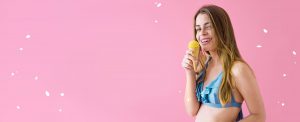 ice cream cone in woman hand with pick background